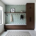 Peel and stick wall tile with a green and white chevron pattern on a feature wall in a contemporary entryway.