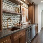 Beautiful kitchen backsplash with patterned tile, wooden cabinetry, and a sleek countertop.