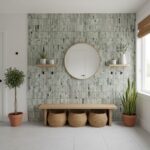 Decorative green striped tile wall with round mirror and potted plants.