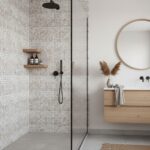 A sleek bathroom featuring a glass tile backsplash in the shower area, complemented by a minimalist vanity and round mirror.