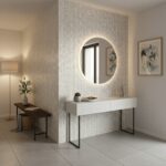 A stylish interior featuring a white shell tile wall with a round mirror, complemented by modern decor and artwork.