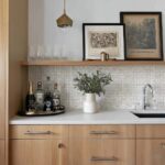 Elegant shell tile backsplash with mother of pearl accents in a modern kitchen setting.