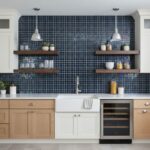 Bright blue glass mosaic tile backsplash behind the sink and countertop.