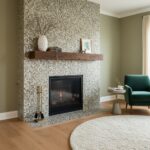 Fireplace with mother of pearl shell tile surround and wooden mantel in a cozy living room setting.