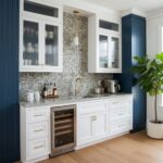 Mother of pearl shell tile used as a stylish kitchen backsplash with white cabinetry and blue accents.