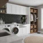 Bright laundry room featuring white cabinetry, black and white tiled backsplash, and wooden open shelves with baskets.