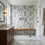 Elegant marble hexagon tiles with a wooden bench in a modern shower.