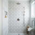 Circular patterned tile in white and gray for shower wall.