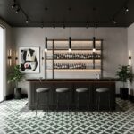 Contemporary bar interior featuring black furniture, geometric patterned tiles, and sleek shelving with bottles, complemented.