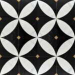 Black and white marble tiles with a circular geometric design and small beige accent tiles.