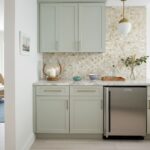 Up of a kitchen backsplash featuring mother of pearl shell tiles in soft, neutral tones.