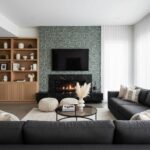 Dark gray and black marble fireplace with textured wall behind.