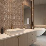 Mother of pearl shell tile accent wall in modern bathroom with white vanity and oval mirror. Elegant and natural design eleme.