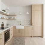 Bright kitchen featuring pearl and shell tile accents behind the sink and stove.