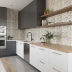 Mother of pearl shell tile backsplash in a modern kitchen with gray and white cabinetry.