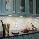 Elegant kitchen backsplash featuring mother of pearl shell tile with iridescent pearl and seashell accents.