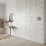 Mother of pearl shell tile wall with small green accents, modern and elegant design for home interiors.