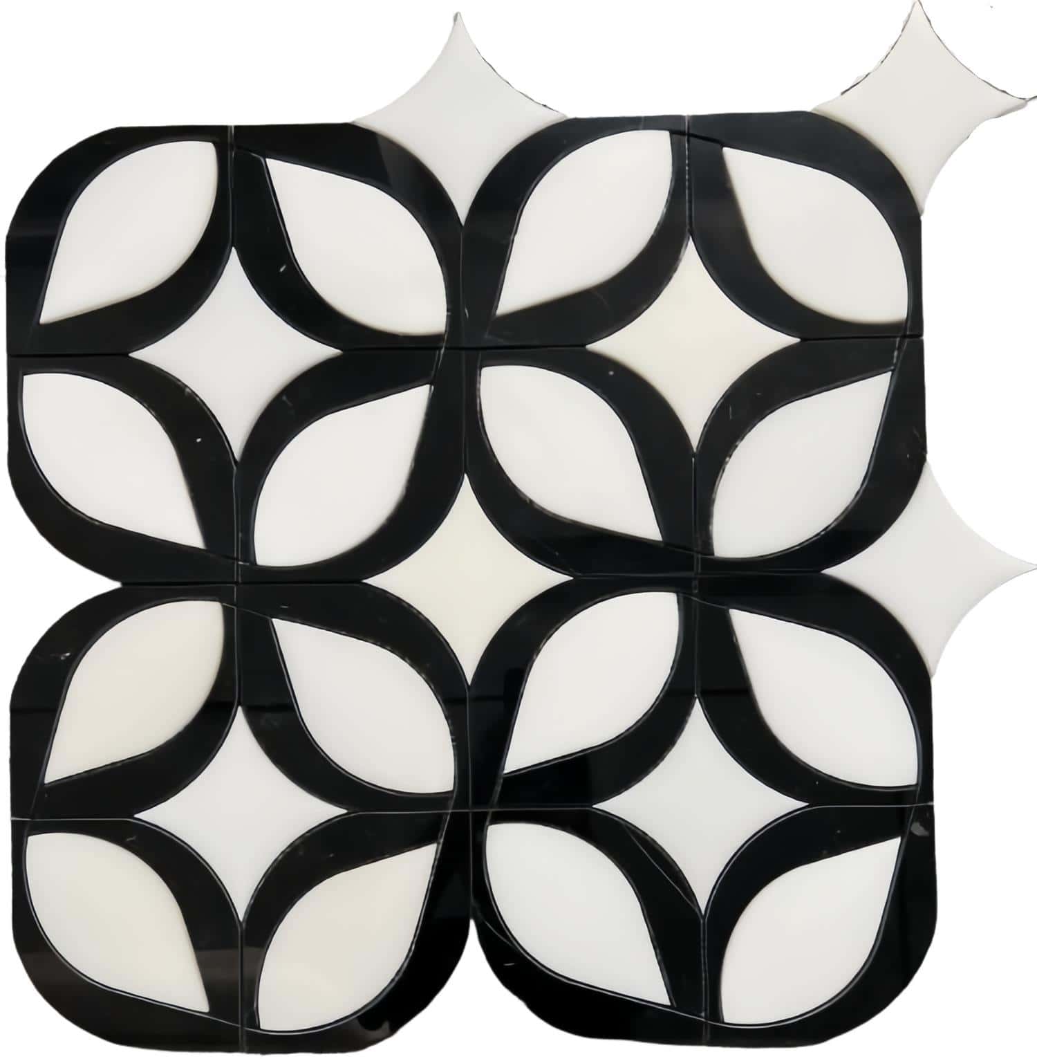 Black and white ceramic tile with a glossy finish and a leaf-like geometric pattern.