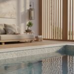 A luxurious indoor pool featuring glass mosaic tiles, creating a sleek and modern look with a relaxing ambiance.