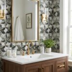 Geometric patterned tile wall in shades of gray, white, and gold, with a textured surface, enhancing the bathroom's modern an.