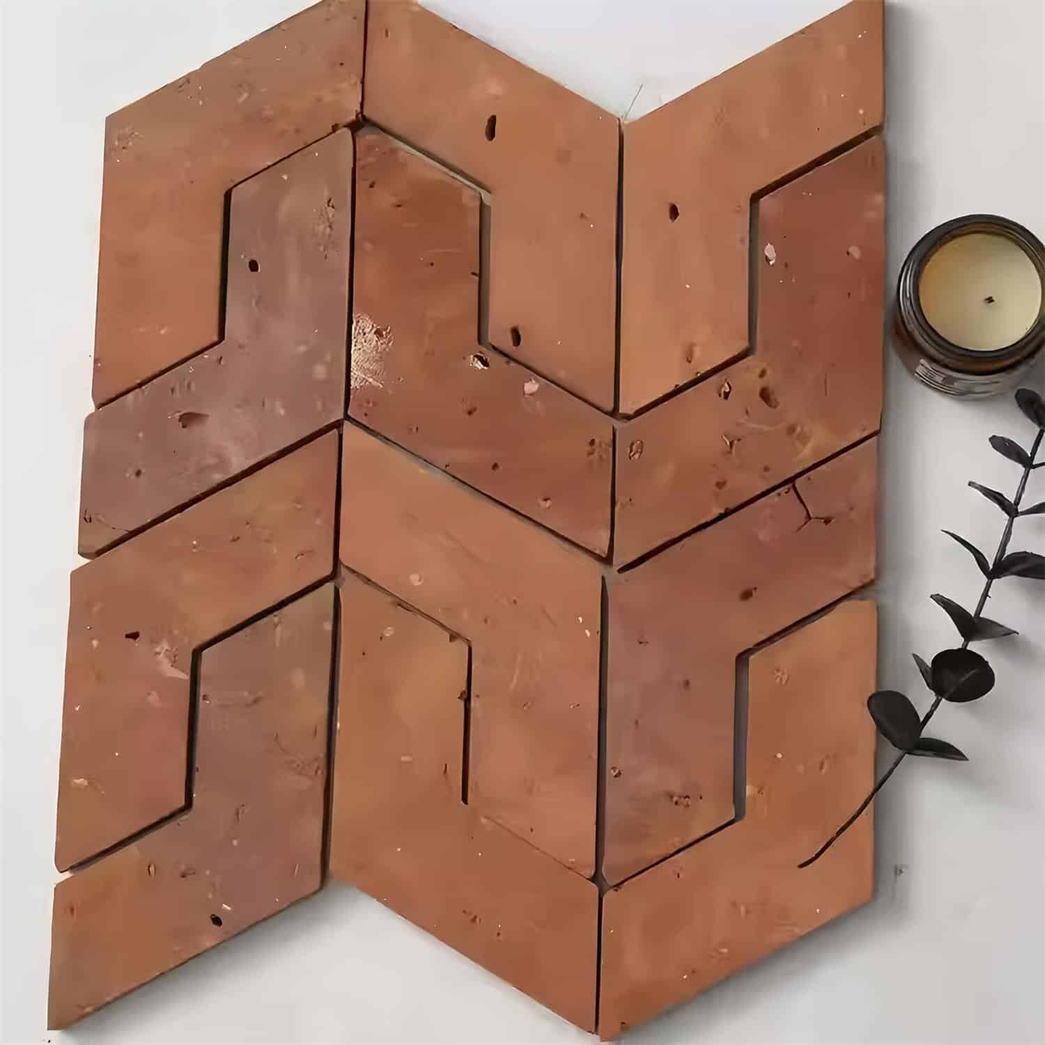 Red clay tiles with a textured surface and geometric cutout pattern.