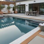 Poolside glass mosaic tile reflecting sunlight and enhancing pool aesthetics.
