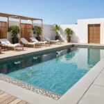 Pool with glass tile backsplash and mosaic accents for a sleek, contemporary look.