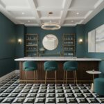 Teal-colored wall with a marble-topped bar, gold accents, and geometric patterned floor tiles in black, white, and gold, crea.