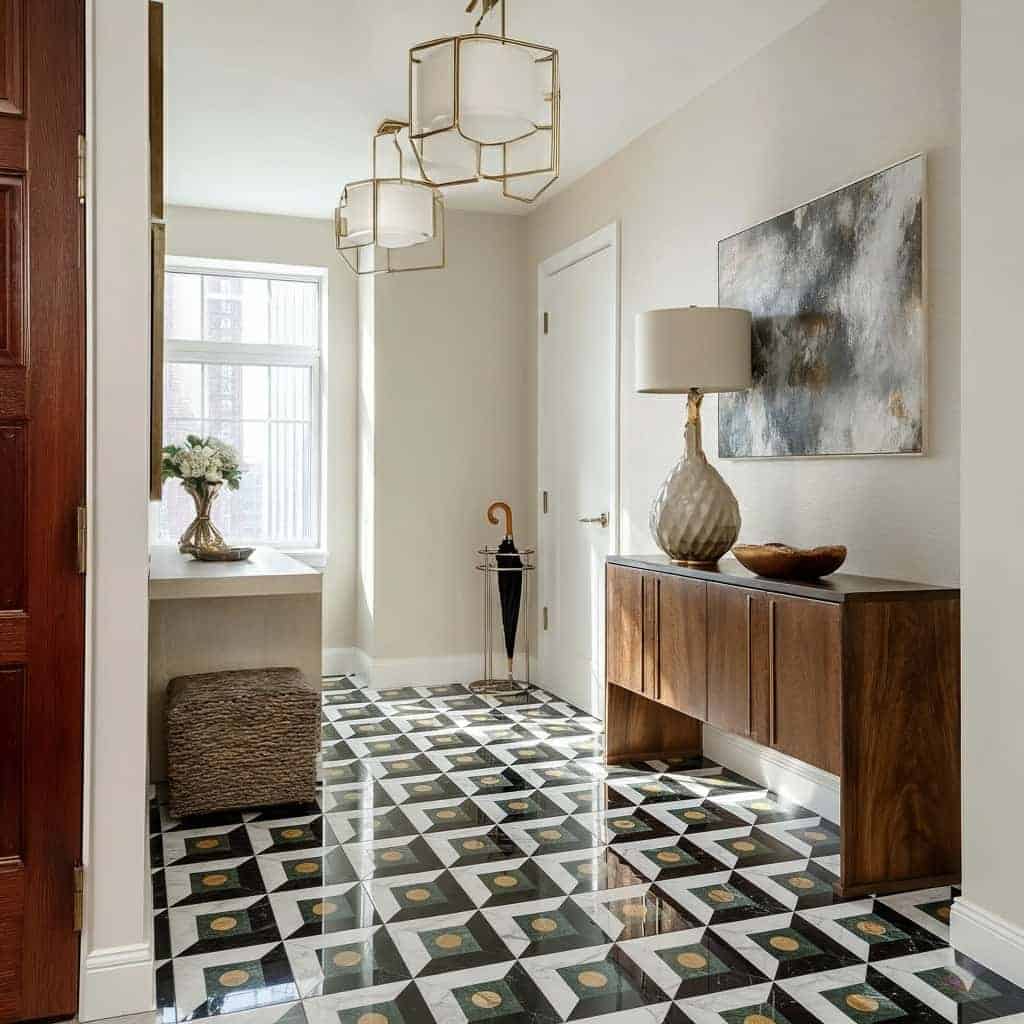Stylish black and white patterned tile with gold details, perfect for contemporary home entryways.