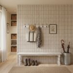Wall panel with beige textured tiles, natural fiber hat, and hanging accessories.