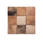 Variety of terracotta and beige tiles with weathered, textured surfaces, showcasing natural clay material and earthy tones.