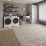 Laundry room with beige mosaic tile flooring, white cabinets, and shelves with decor.