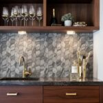 Modern kitchen backsplash with peel and stick tiles, gold fixtures, and decorative accents.