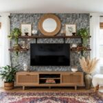 Modern living room with peel and stick wall tile behind TV, featuring decorative shelves and plants.