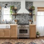 Bright kitchen with peel and stick wall tile backsplash and wooden cabinets.