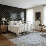 Elegant black and gold patterned tile on bedroom accent wall, adding a luxurious touch to the space.