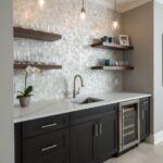 A modern kitchen featuring a stunning mother of pearl shell tile backsplash with floating wooden shelves and sleek black cabi.