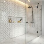 Bright white circular tile pattern with smooth marble surfaces in a sleek shower design.