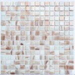 Up of a glass mosaic tile backsplash featuring small, square glass tiles in neutral tones, ideal for pool and bathroom design.