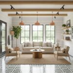 Bright white living room with textured tile flooring, wooden ceiling beams, and neutral-toned furniture. Features large windo.