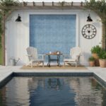 A relaxing outdoor space featuring a blue glass mosaic tile backsplash behind two white chairs and a small table, perfect for.