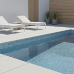 Poolside glass mosaic tile for a modern backyard pool area.
