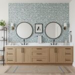 Bathroom vanity with glass mosaic tile backsplash, double mirrors, and modern decor.