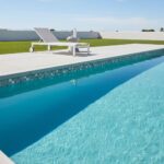 Poolside glass mosaic tile for a modern backyard design, featuring a sleek, reflective surface that enhances the pool's aesth.