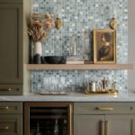 Glass tile backsplash with mosaic design and decorative accents.