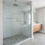 Glass shower enclosure with sleek, clear panels and minimalist hardware.