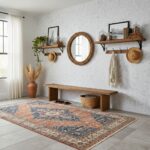 A cozy entryway with a wooden bench, wall-mounted shelves, framed photos, hats, and decorative jars, creating a warm and invi.
