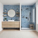 Blue glass tile backsplash in bathroom with shower and vanity.