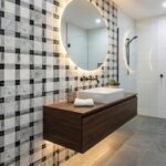 Black and white checkered ceramic tiles with a smooth finish and textured pattern.
