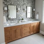 Double vanity with shell tile backsplash and modern mirrors.
